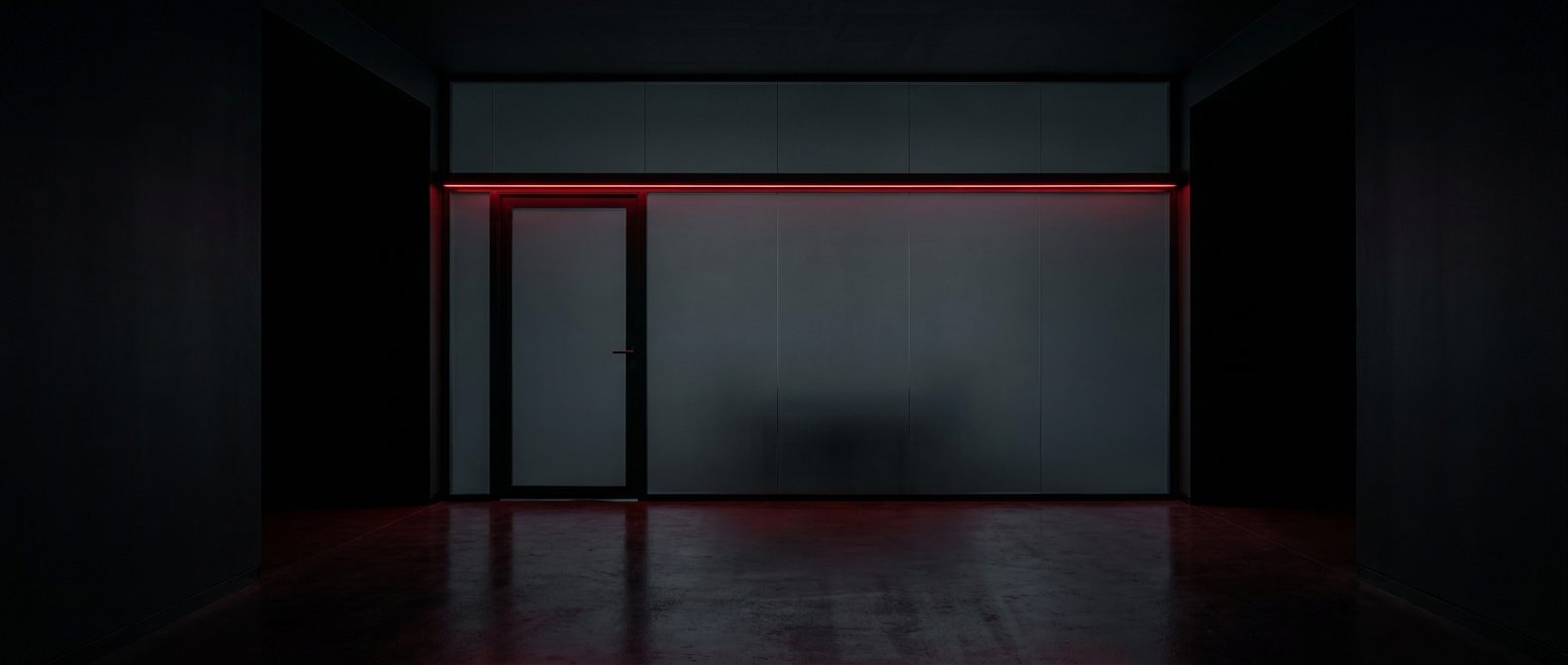 Opaque glass meeting room with a red in-use LED strip